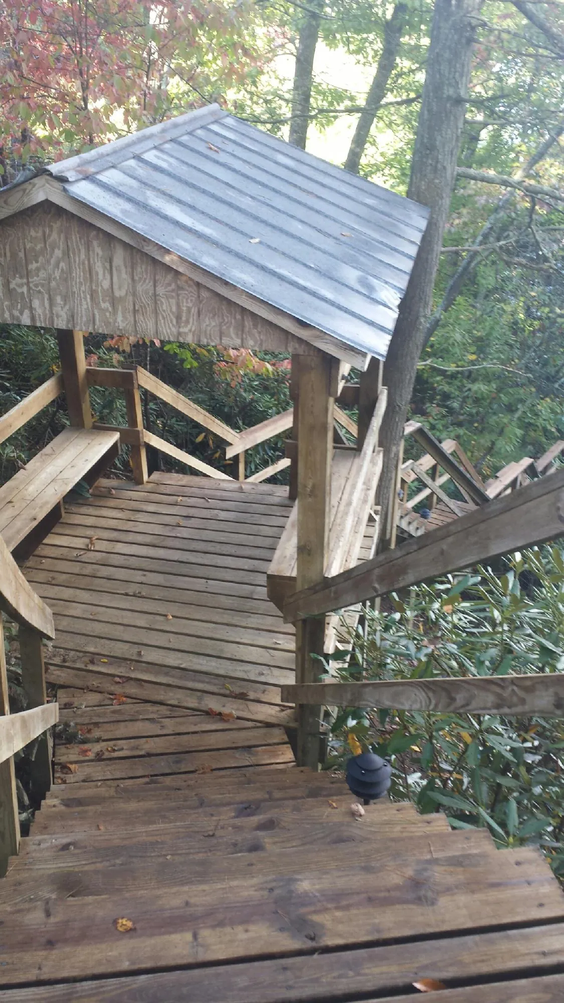 Metal roofed shelter over wooden steps on a wooded walkway — Skylight Repair & Installation work by our crew in Leck Kill