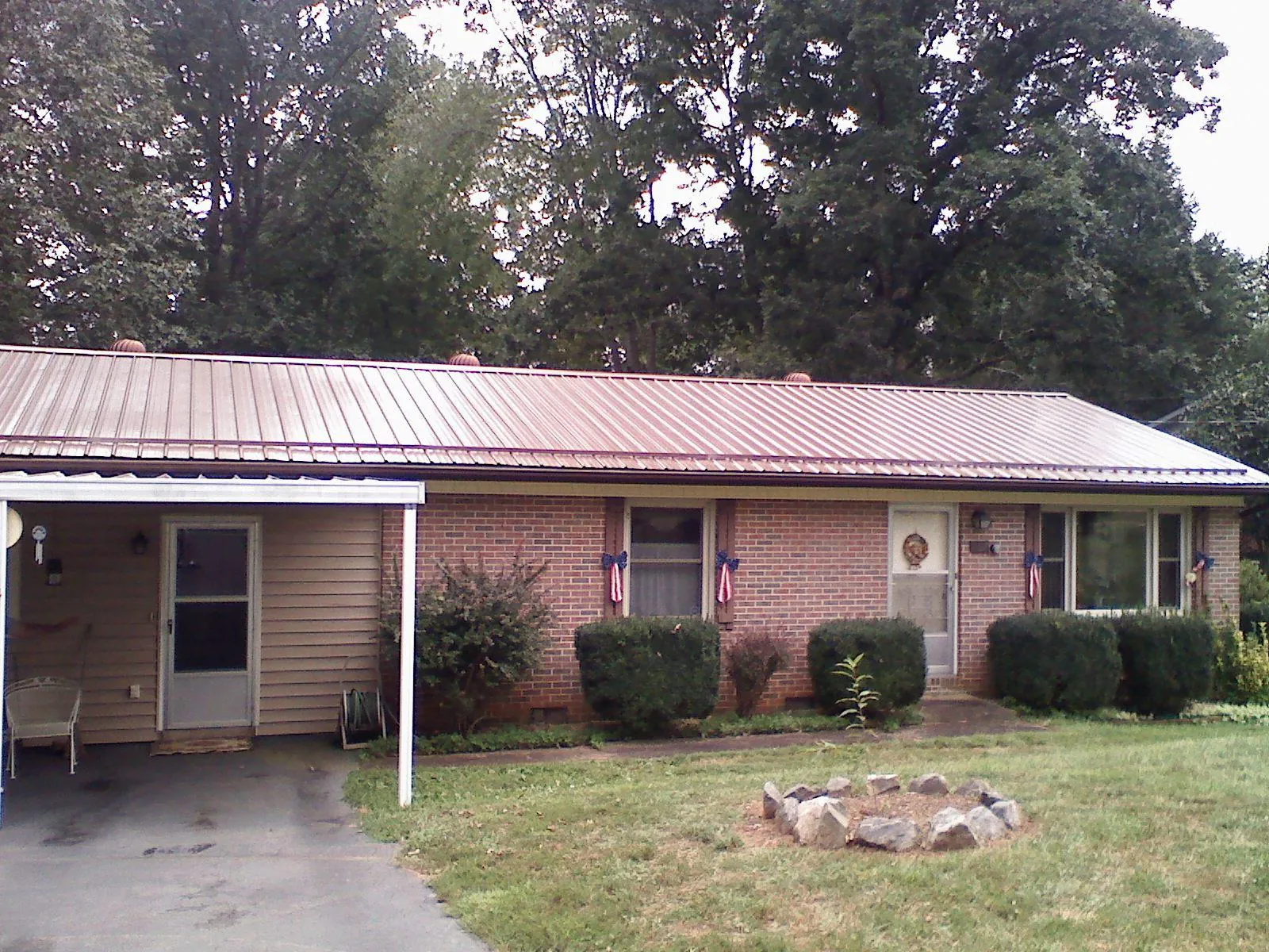Bronze metal roof and carport on a brick ranch home — Roof Repair work by our crew in Leck Kill